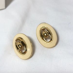 Earrings in gold tone and cream color, oblong shape
